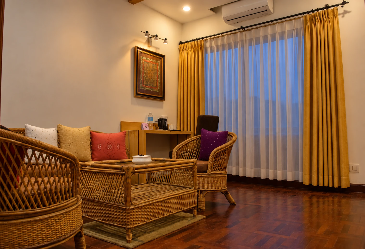 Fresco Club Suite living room with wicker seating and a workspace